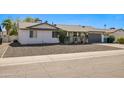 Charming single-story home with a two-car garage and xeriscaped front yard at 3619 E Friess Dr, Phoenix, AZ 85032