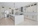 Open kitchen with large island, stainless steel appliances and bright pendant lighting at 4409 N 32Nd St, Phoenix, AZ 85018