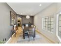 Dining room with table and chairs, complemented by an elegant rug and modern lighting at 493 E Baylor Ln, Gilbert, AZ 85296