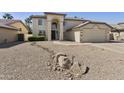 Two-story home with low-maintenance desert landscaping in front yard at 493 E Baylor Ln, Gilbert, AZ 85296