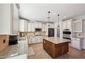 Bright, fully equipped kitchen with granite countertops, a central island, and stainless steel appliances at 5779 S Penrose Dr, Gilbert, AZ 85298