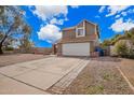 Suburban two story home with desert landscaping, an extra wide driveway and a two-car garage at 6533 E Beverly Ln, Scottsdale, AZ 85254