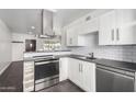 Updated kitchen with stainless steel appliances, white subway tile backsplash, and modern countertops at 749 E Montebello Ave # 228, Phoenix, AZ 85014