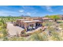 Beautiful Santa Fe style home boasts a private drive and desert landscaping with mountain views at 8154 E Tecolote Cir, Scottsdale, AZ 85266