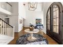 Welcoming foyer showcases hardwood floors, modern light fixtures, and opens to living spaces and the staircase at 8654 E Thoroughbred Trl, Scottsdale, AZ 85258