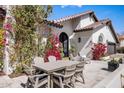 Outdoor patio features a dining table surrounded by mature landscaping, offering an ideal space for entertaining at 8654 E Thoroughbred Trl, Scottsdale, AZ 85258