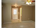 View of the carpeted living room featuring tile flooring near the entry door at 1044 S Mosley Dr, Chandler, AZ 85286