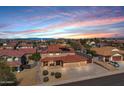 Stunning aerial view of a suburban neighborhood with a terracotta-roofed home, surrounded by desert landscaping at 10520 W Patrick Ln, Peoria, AZ 85383