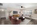 Cozy living room with neutral walls, wood-look floors, and a ceiling fan with light at 1215 W Dublin St, Chandler, AZ 85224