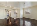 Open living space with wood floors adjoins a functional kitchen, providing a modern and connected living experience at 12221 W Bell Rd # 215, Surprise, AZ 85378