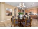 Bright dining area with a glass top table, seating for four, and backyard views at 12820 W La Vina Dr, Sun City West, AZ 85375