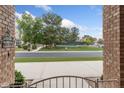 View from porch of landscaped front yard, neighborhood street, and tennis courts at 1321 W Gardenia Ave, Phoenix, AZ 85021