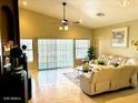 Bright living room with expansive windows, tile floors, and neutral paint at 14240 N Ibsen Dr # B, Fountain Hills, AZ 85268