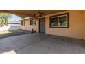 This exterior shot highlights a covered porch with a ceiling fan, offering a shaded outdoor living space at 1427 W 6Th Dr, Mesa, AZ 85202