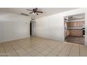 This room features neutral tile flooring and access to the kitchen, providing a versatile space at 1427 W 6Th Dr, Mesa, AZ 85202