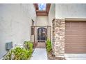 Elegant gated entrance with stone accents leading to a front door at 150 N Lakeview Blvd # 1, Chandler, AZ 85225