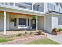 Inviting front porch with a swing and manicured landscaping at 19450 E Silver Creek Ln, Queen Creek, AZ 85142