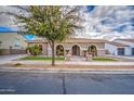 Charming single-story home features manicured landscaping and a welcoming arched entryway at 21186 E Sunset Dr, Queen Creek, AZ 85142