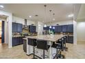 Spacious kitchen features granite countertops and a large island with seating at 21186 E Sunset Dr, Queen Creek, AZ 85142