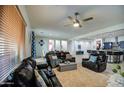 Inviting living room with plush seating, neutral carpet, and abundant natural light at 21186 E Sunset Dr, Queen Creek, AZ 85142