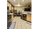 Bright eat-in kitchen with maple cabinets and modern stainless steel appliances at 2251 E Parkside Ln, Phoenix, AZ 85024