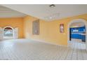 Spacious living area boasting abundant natural light, arched doorway, and view of a blue kitchen at 3022 E Weldon Ave, Phoenix, AZ 85016