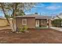 Charming single-story brick home featuring a well-maintained lawn and tasteful landscaping at 309 W Campbell Ave, Phoenix, AZ 85013