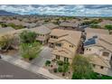 Panoramic aerial view of a two-story home showcasing its manicured front yard and lengthy driveway at 3712 S 104Th Ln, Tolleson, AZ 85353