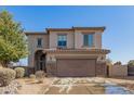 Attractive two-story home featuring a two-car garage and neutral stucco exterior with easy-care landscaping at 599 W Agrarian Hills Dr, San Tan Valley, AZ 85143