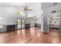 Bright living room with wood floors, high ceilings, a fireplace, and access to the backyard through glass doors at 730 E Rosemonte Dr, Phoenix, AZ 85024