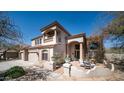 Beautiful home exterior with a well-maintained lawn, arched entry, and colorful bougainvillea at 7418 E Sandia Cir, Mesa, AZ 85207