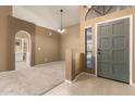 Inviting foyer with neutral paint, tile flooring, chandelier, and an arched entry leading to the living spaces at 830 N Cholla St, Chandler, AZ 85224