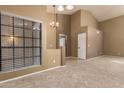 Spacious living room featuring neutral paint, carpet, high ceilings, and a view into the kitchen at 830 N Cholla St, Chandler, AZ 85224