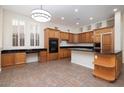 Open kitchen featuring an island, breakfast bar, stainless steel appliances, and ample counter space at 9435 E Mohawk Ln, Scottsdale, AZ 85255