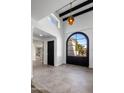 Entryway showcasing high ceilings, arched window and a glimpse of the home's modern design at 9675 E Cinnabar Ave, Scottsdale, AZ 85258