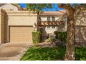 Charming home featuring a two-car garage, well-manicured lawn and desert landscaping at 9705 E Mountain View Rd # 1056, Scottsdale, AZ 85258