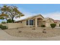 Charming home featuring desert landscaping, a private front yard, and neutral stucco exterior at 10012 W Runion Dr, Peoria, AZ 85382
