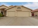 This home features a spacious driveway and a 2-car garage at 10012 W Runion Dr, Peoria, AZ 85382