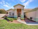 Inviting front entrance with well-manicured lawn, lush landscaping and a beautiful walkway at 11133 W Laurelwood Ln, Avondale, AZ 85392