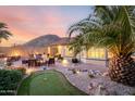 Beautiful backyard featuring a putting green, fire pit, and patio area perfect for entertaining at 1197 W Rolls Rd, San Tan Valley, AZ 85143