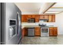 Functional kitchen featuring stainless steel appliances and wood cabinets for ample storage space at 1209 N 87Th St, Scottsdale, AZ 85257