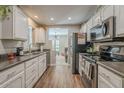 Functional kitchen with white cabinets, stainless steel appliances, and easy access to living room at 12438 N Saguaro Blvd # 108, Fountain Hills, AZ 85268