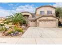 Inviting two-story home with a three-car garage and professionally landscaped yard at 13331 W Romain Ct, Litchfield Park, AZ 85340