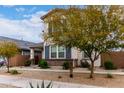 Charming two-story home boasting well-maintained landscaping and an inviting front entrance at 14175 W Bronco Trl, Surprise, AZ 85387