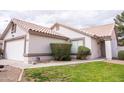 Exterior shot shows well-manicured lawn and neutral-colored exterior, complemented by desert landscaping at 1502 E Detroit St, Chandler, AZ 85225