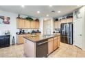 Spacious kitchen island and stainless appliances offer plenty of room for cooking and entertaining at 1785 S 222Nd Ln, Buckeye, AZ 85326