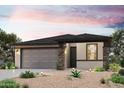 Beautiful single-story home with a two-car garage and desert landscaping at 18243 W Daley Ln, Surprise, AZ 85387