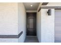 Inviting front entry with a stylish black door and decorative accents at 18243 W Daley Ln, Surprise, AZ 85387
