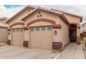 Well-maintained single-story home featuring a two-car garage and desert landscaping at 2025 N 106Th Dr, Avondale, AZ 85392