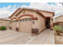 Charming single-story home with a two-car garage and low-maintenance desert landscaping at 2025 N 106Th Dr, Avondale, AZ 85392